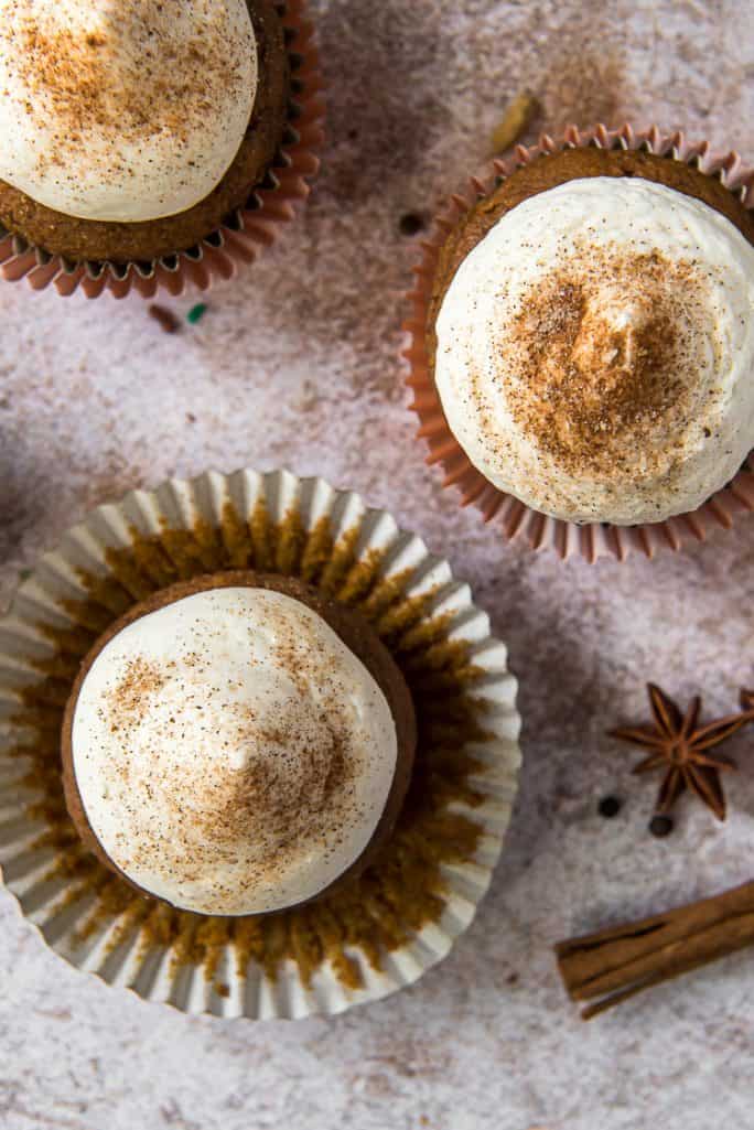a chai pumpkin cupcake with the wrapper peeled back