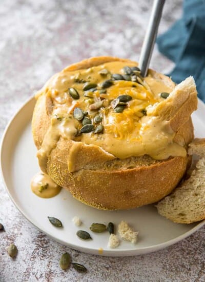 pumpkin broccoli cheddar soup in a sourdough bread bowl