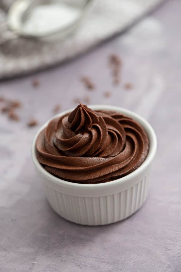 chocolate buttercream frosting piped into a small bowl