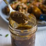 teriyaki sauce being lifted out of a mason jar on a spoon