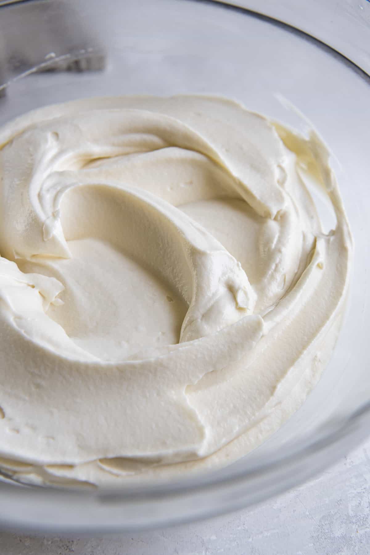 a pretty bowl of whipped cream cheese frosting