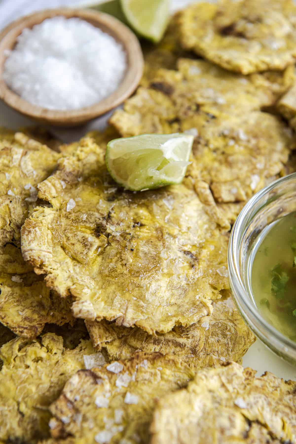 air fried tostones with lime and salt on a white plate