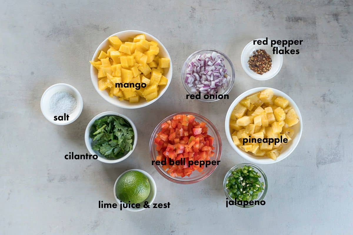 ingredients for pineapple mango salsa in individual bowls
