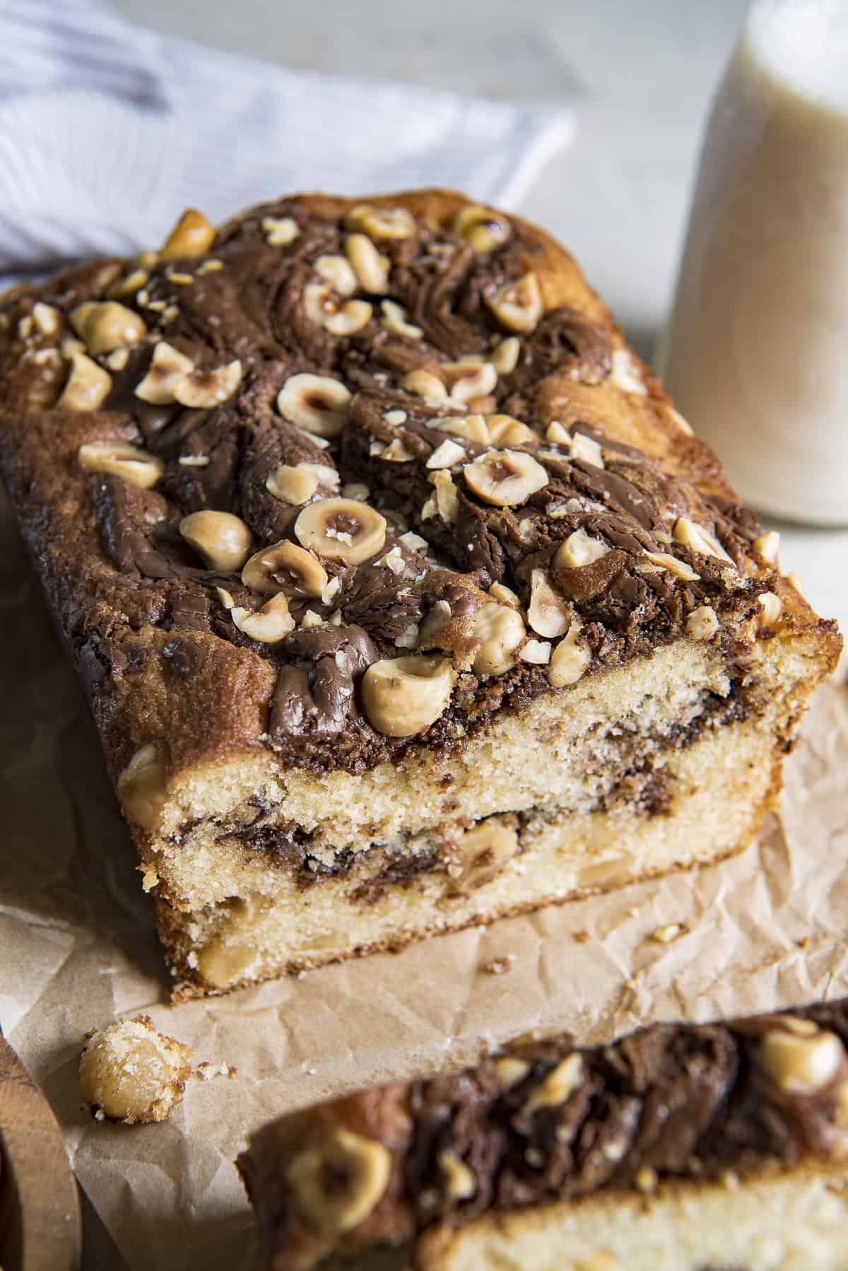 a cut loaf of nutella bread with hazelnuts on top