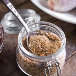a spoonful of blended smoked chicken rub in a small jar