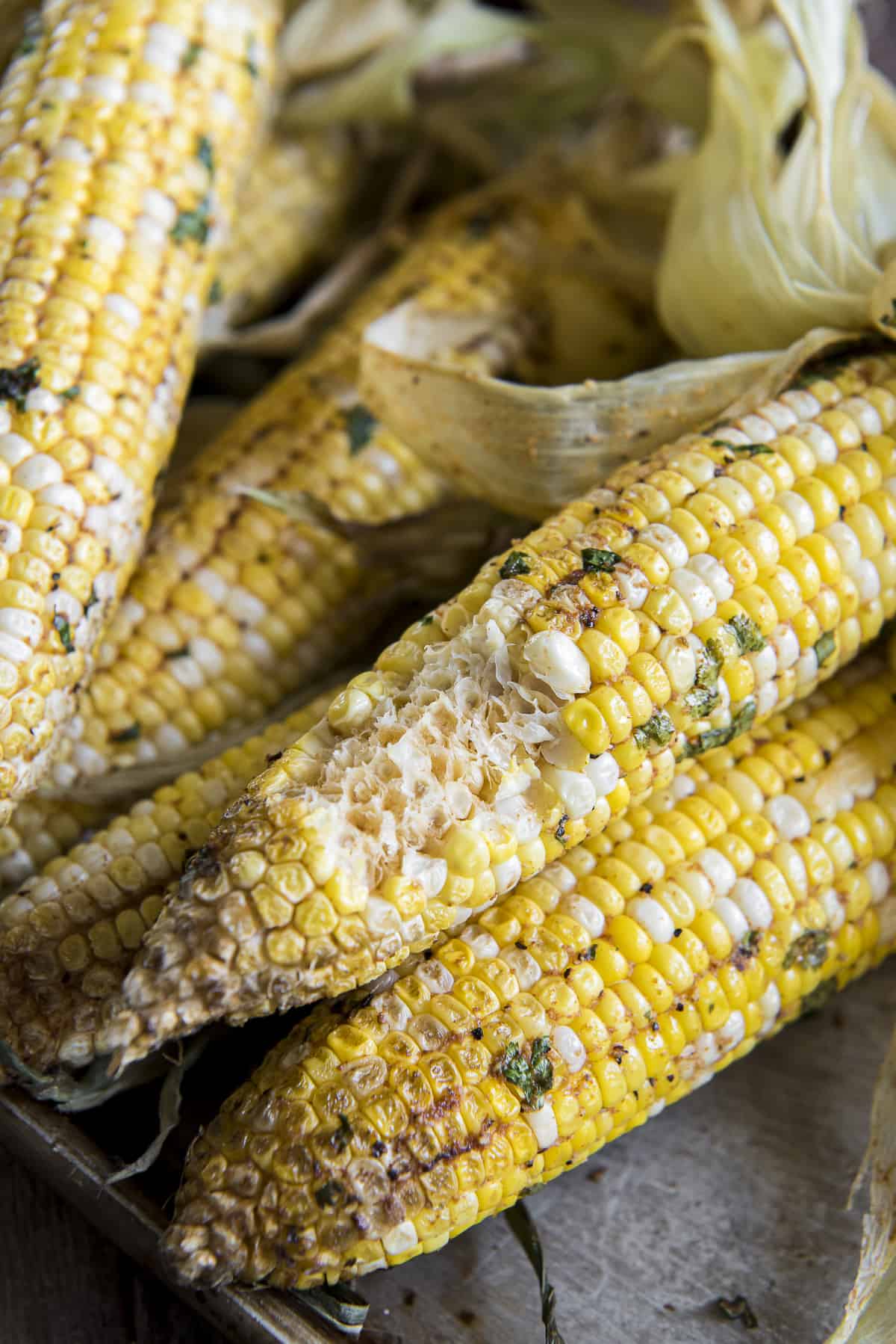 a stack of half eaten smoked corn on the cob