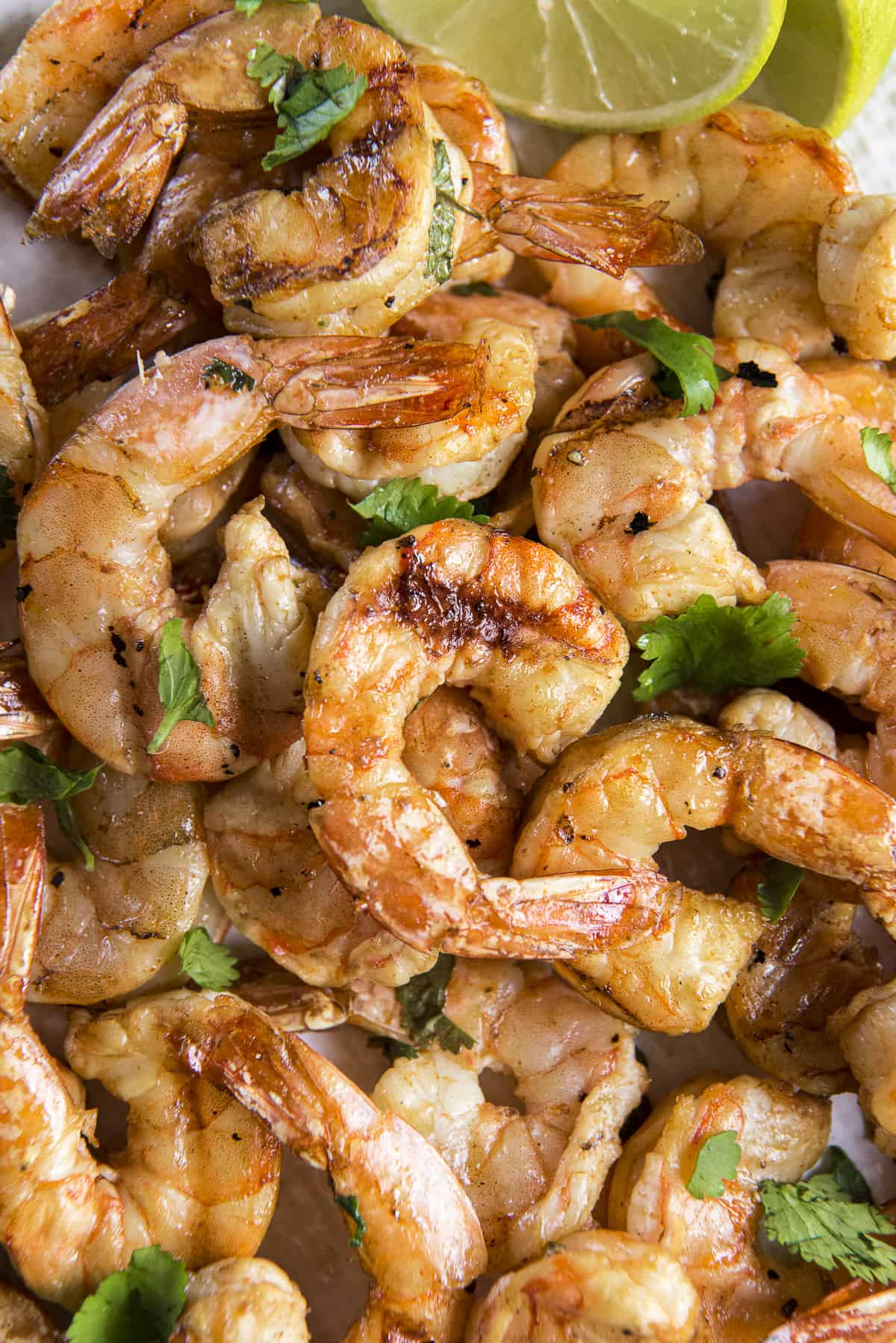 A pile of smoked shrimp on a plate with cilantro