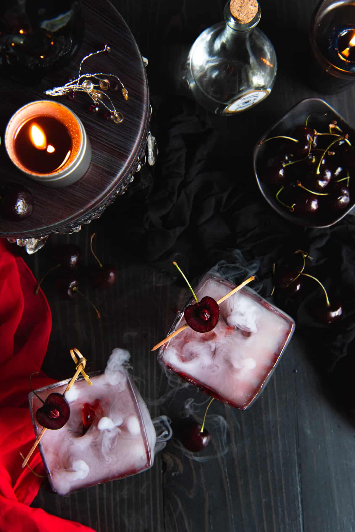 Cocktails with cherries on top of them.
