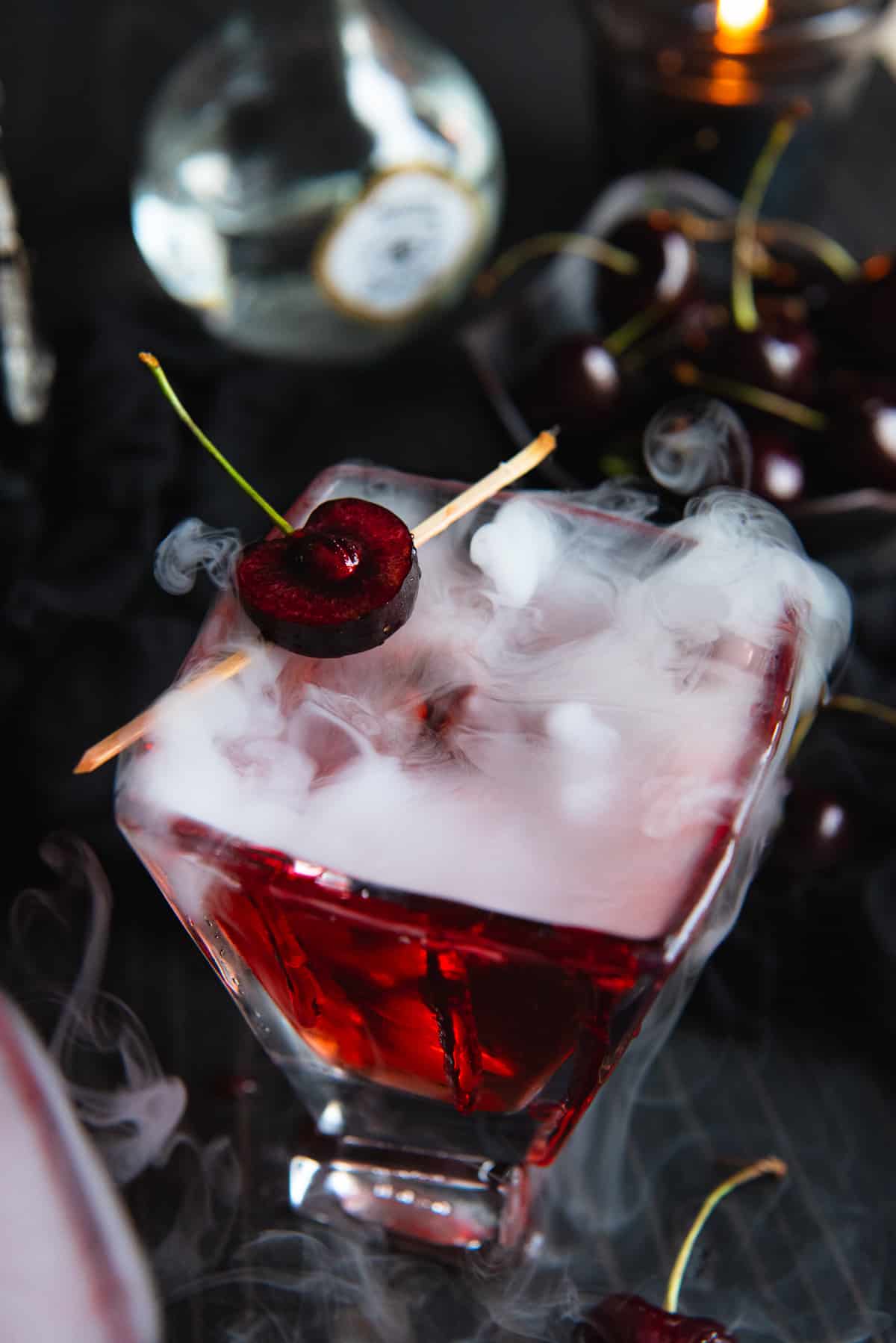 A cocktail with a cherry on top of it.
